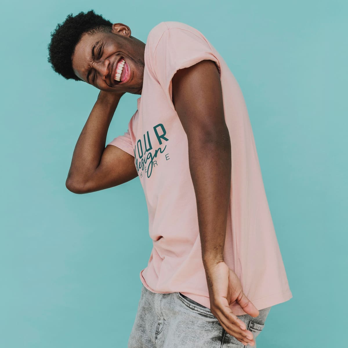 Man wearing a pink custom t-shirt with logo design on a turquoise background