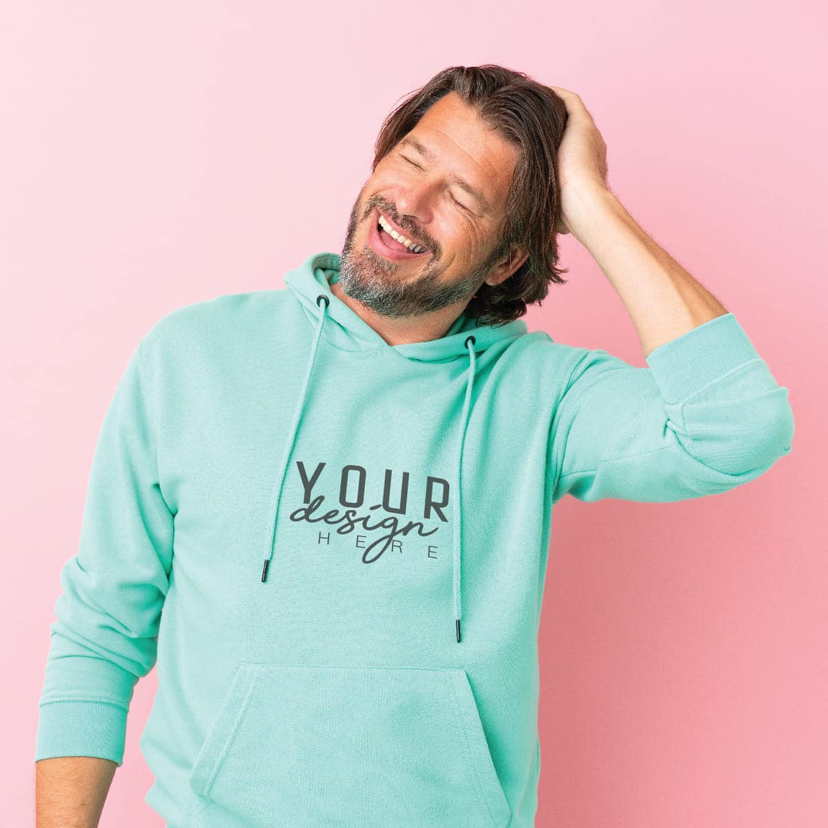Man wearing a mint green custom hoodie with logo design on a pink background